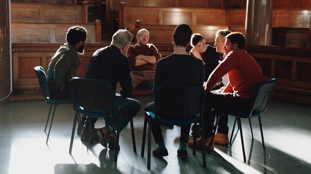 a group of men at a gambling addiction meeting