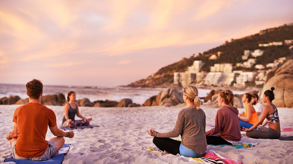 A group of people seated outdoors at a meditation retreat