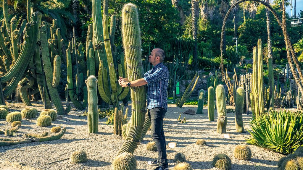 Man hugging a cactus in an example of unrequited love