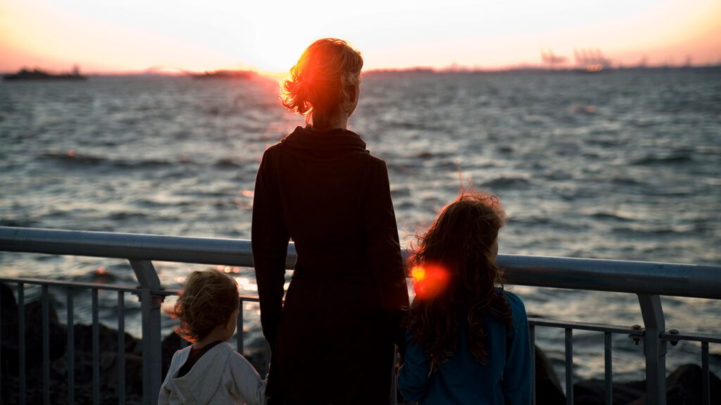 Silhouette of mother who has bipolar disorder and her two young kids, 