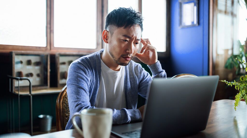 man sitting at computer aggravated by a low frustration tolerance