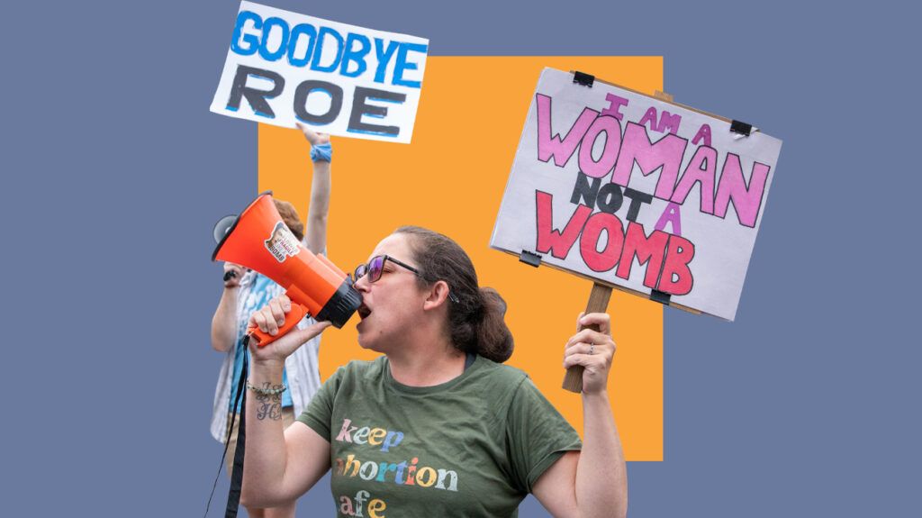 Woman holding signs protesting Roe vs. Wade overturn