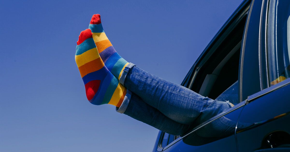 https://media.post.rvohealth.io/wp-content/uploads/sites/4/2022/07/feet-colorful-socks-legs-sticking-out-of-car-window-1200x628-facebook-1200x628.jpg