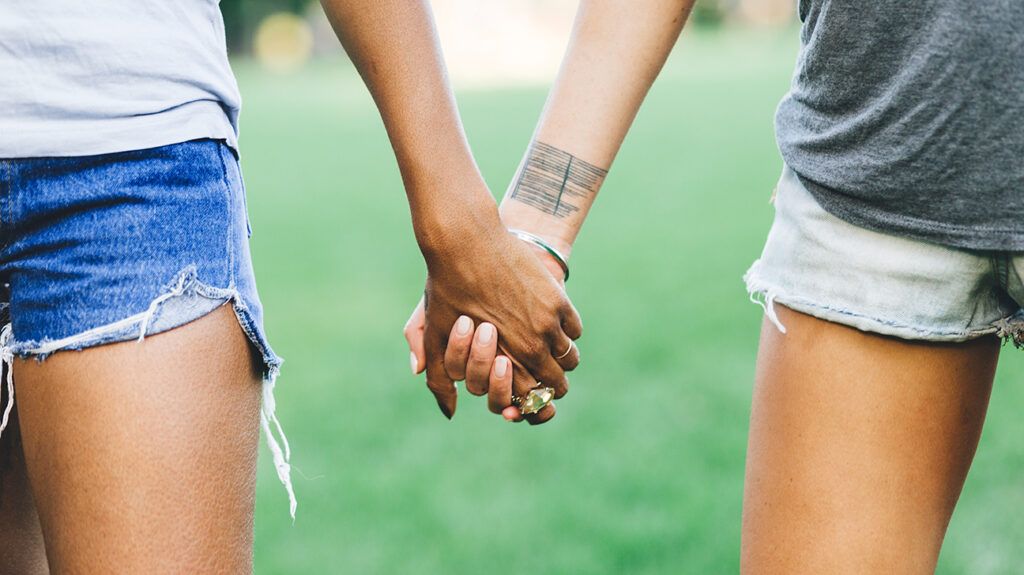 Friends holding hands, enjoying a meaningful relationship