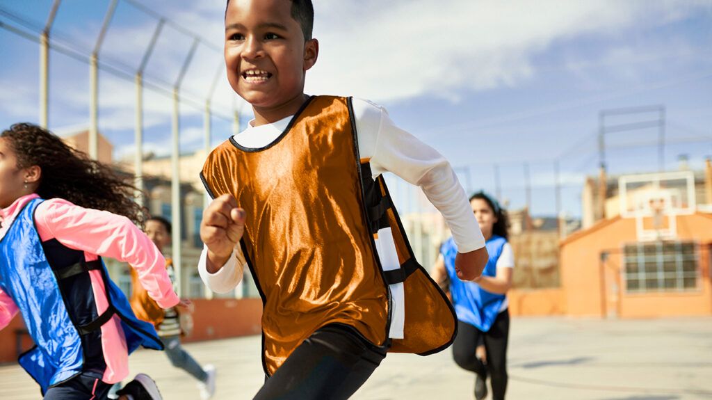 Child with sound prosocial behavior running on playground