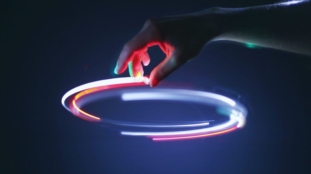 Person trying to control a glow stick in the dark, symbolizing the illusion of control