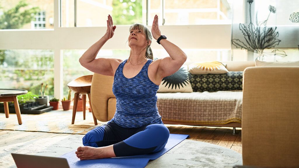 Older woman stretching on floor as an alternative regimen for her anxiety
