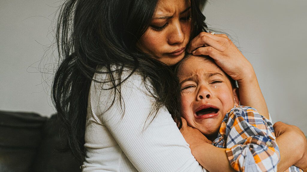 Mother consoles stressed out child who is crying