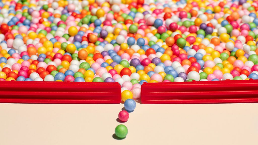 an opening in the boundary of colored balls gives way to rolling away balls