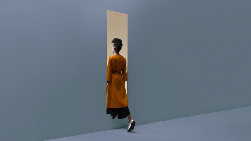 Woman walking through a door, symbolic of stepping into help for mental health