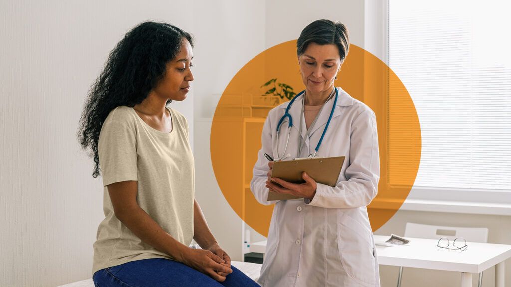 a patient sitting down speaking with their doctor