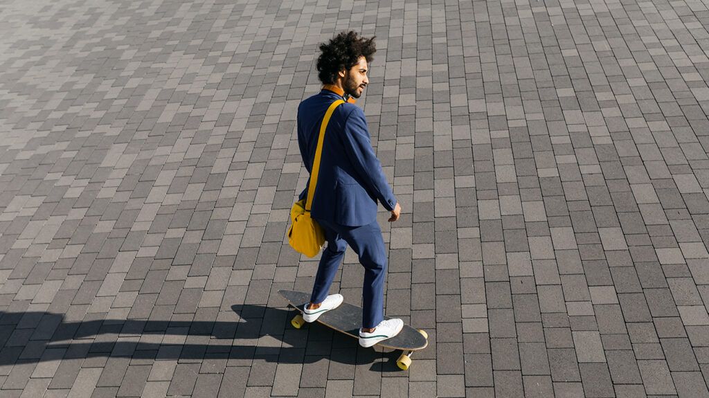 Man skateboarding away from work