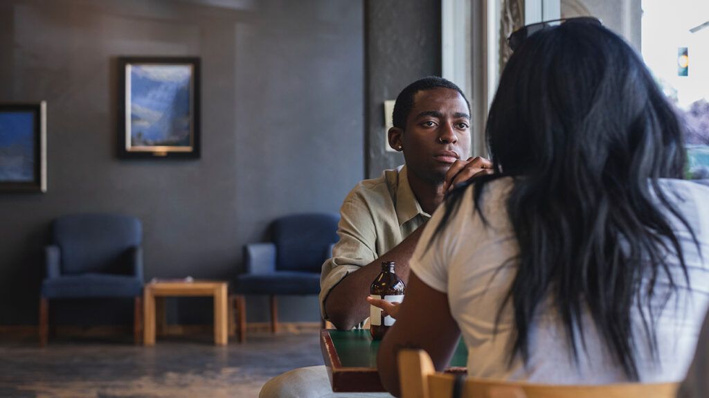 Man speaking with person, being vulnerable