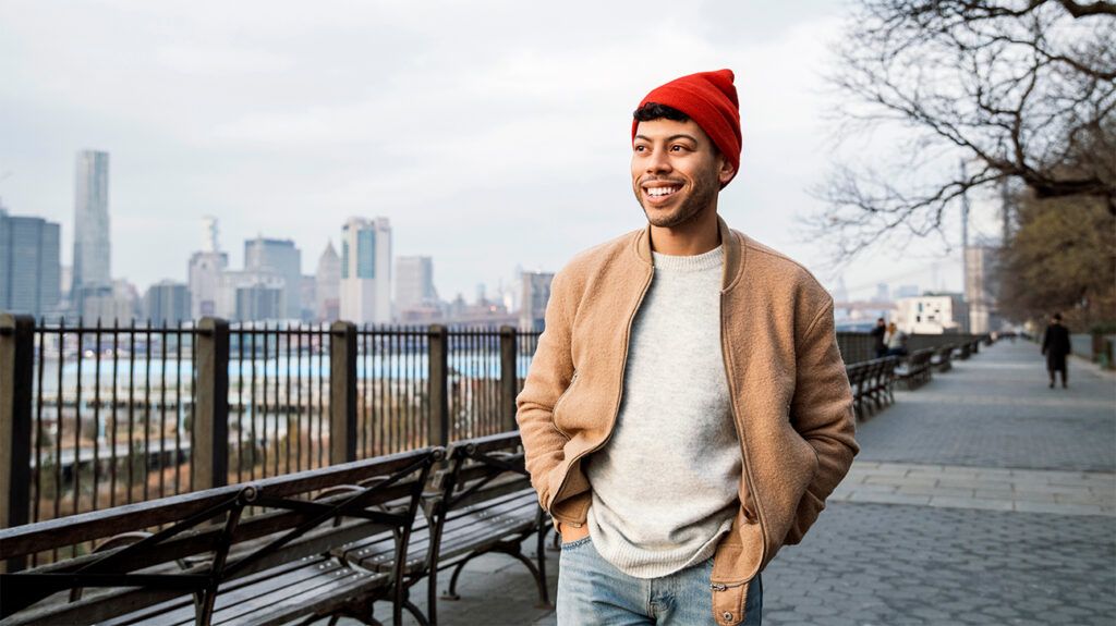 A man happily walking outside