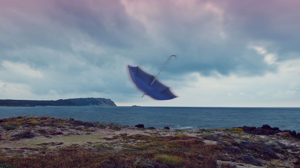 an umbrella being blown by the wind