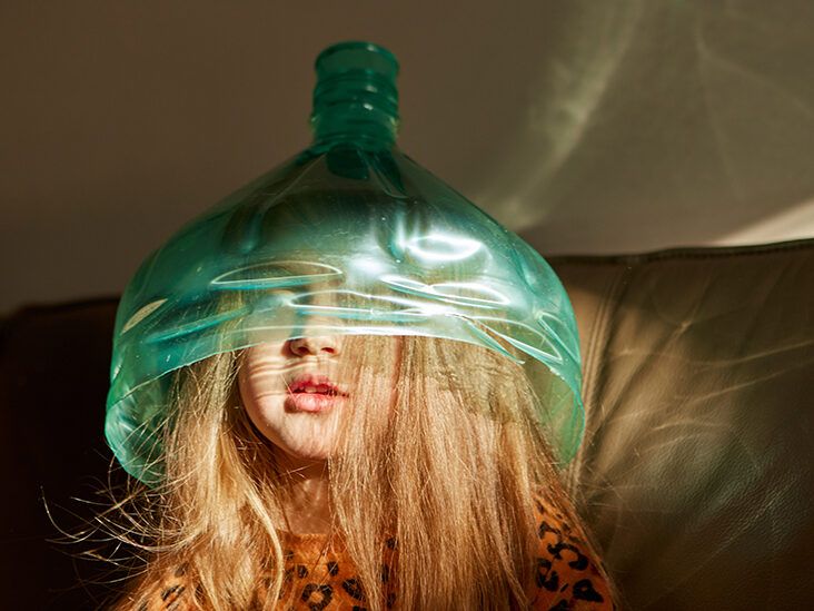 https://media.post.rvohealth.io/wp-content/uploads/sites/4/2023/09/child-playing-wearing-plastic-bottle-on-head-sunlight-732x549-thumbnail-732x549.jpg