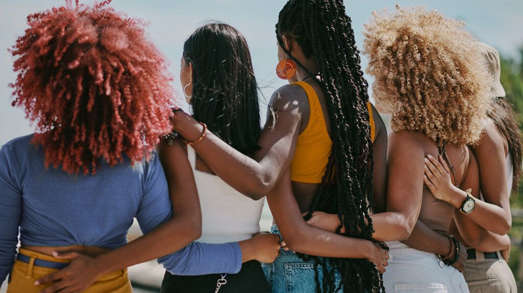 a group of female friend embracing one another