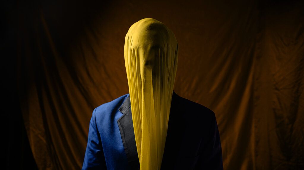 a man with his face covered by a cloth