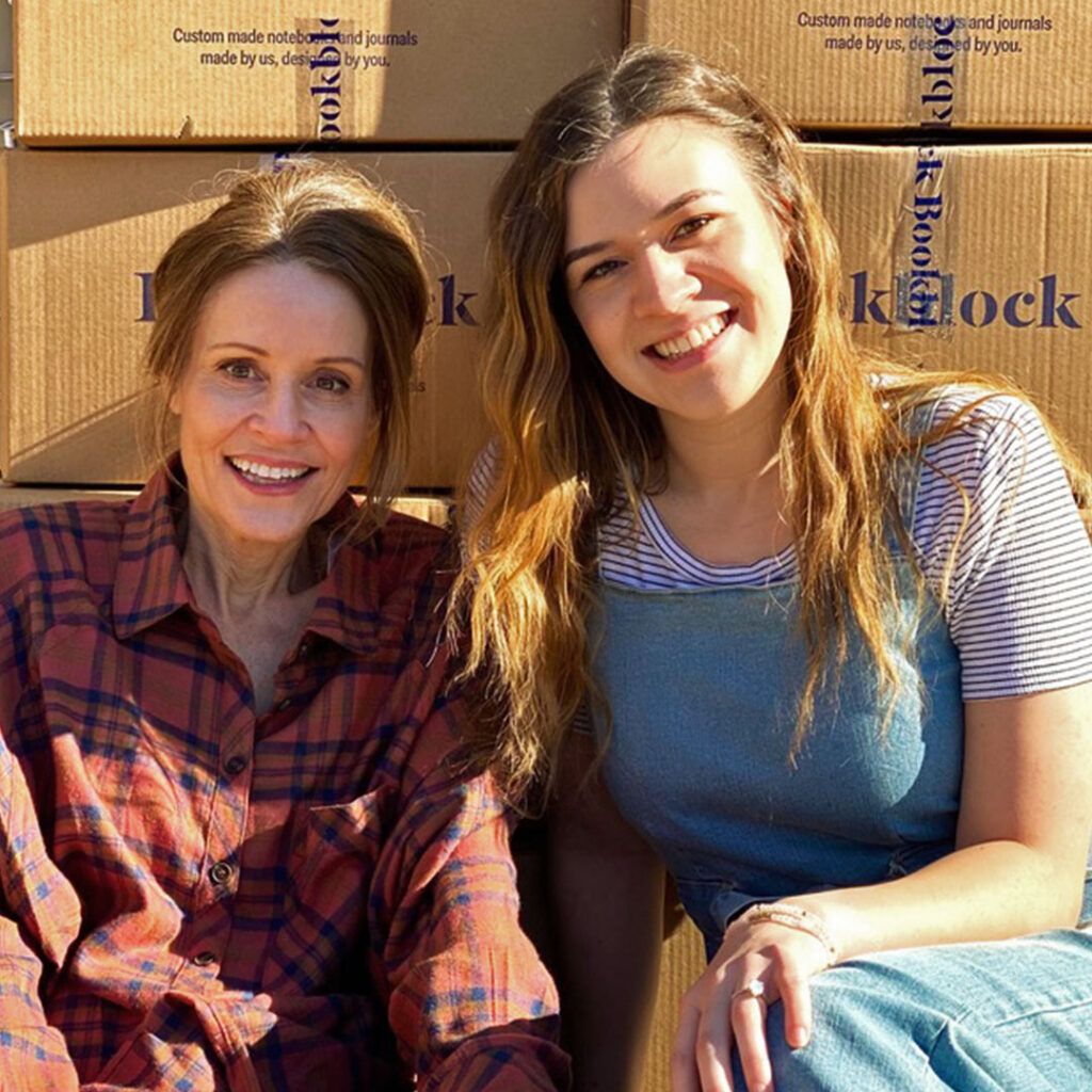 Nicole and Aisley, founders of the Mindflight Journal, sitting in front of their first orders