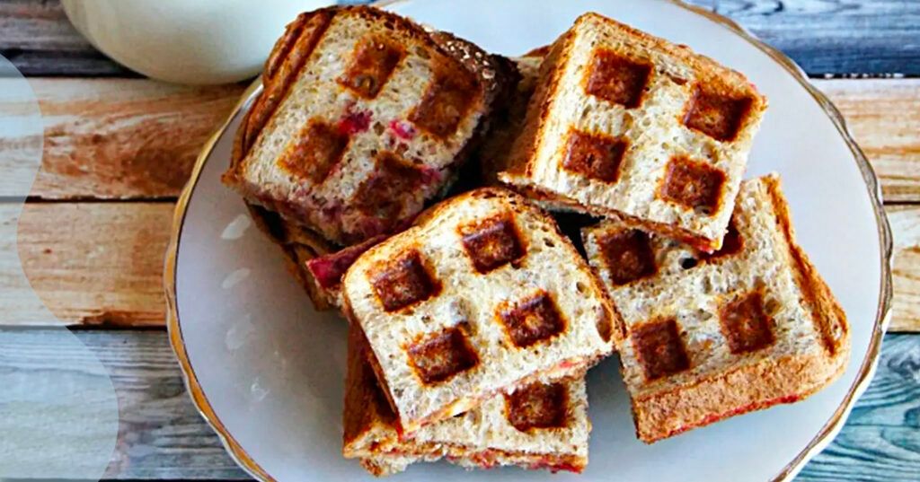 Peanut butter and jelly sandwiches that have been pressed in a waffle maker.