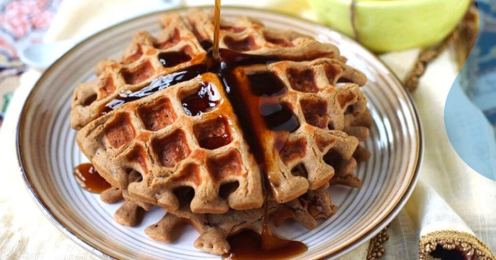 Quinoa high-protein waffles with butter and syrup.