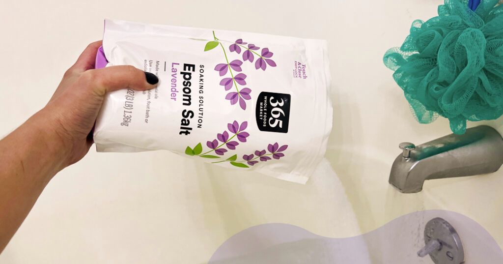 The author pours lavender-scented Epsom salt into her bathtub.