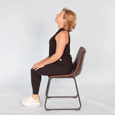A GIF of someone living with COPD performs the chair exercise: cat cow.