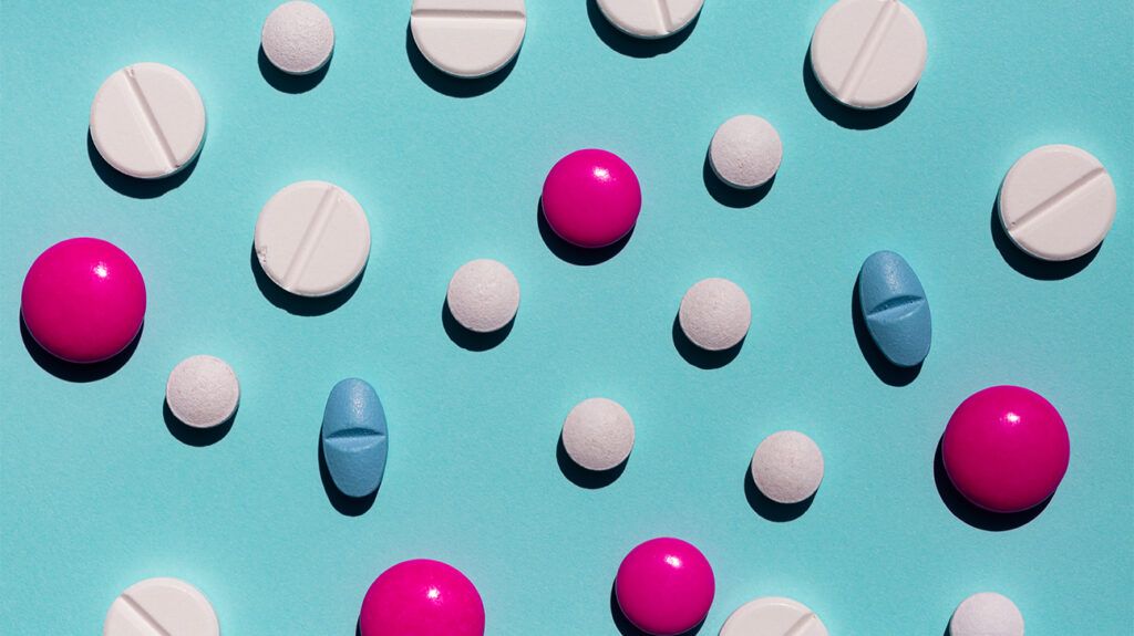 Multiple differently shaped and colored pills representing blood clot treatments