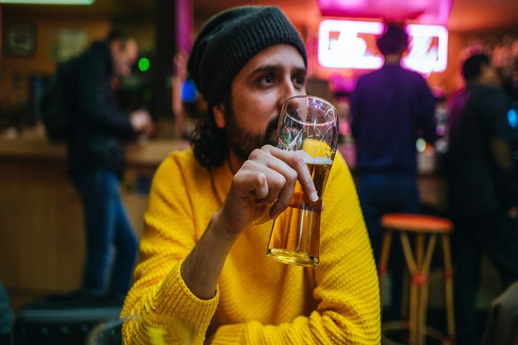 A person drinking beer in a bar