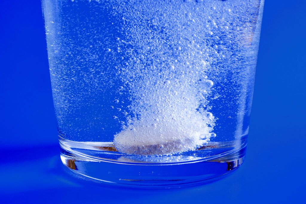 Effervescent antacid tablet in a glass of water