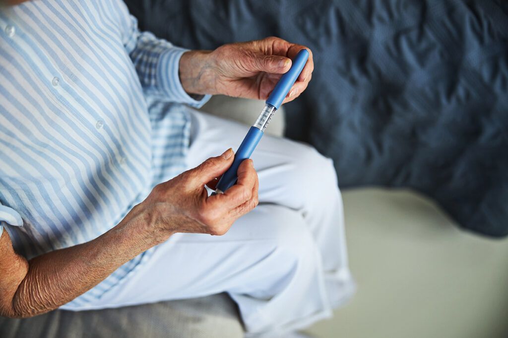 An image of someone holding an injection.