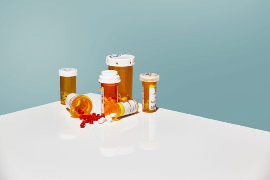 An image of antiviral medications in prescription bottles.