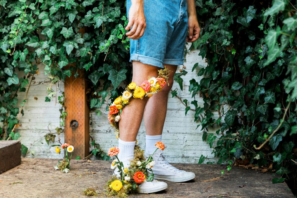 Man with flowers wrapping up his leg
