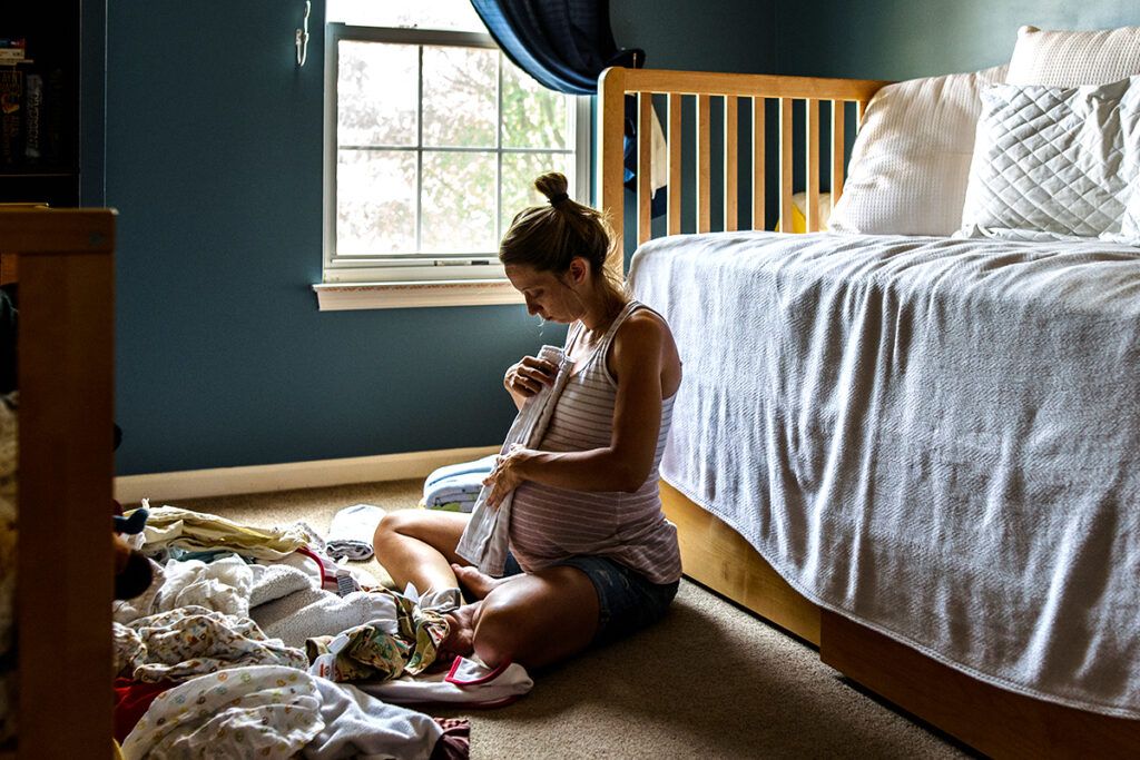 Pregnant woman with Crohn's disease preparing baby's nursery