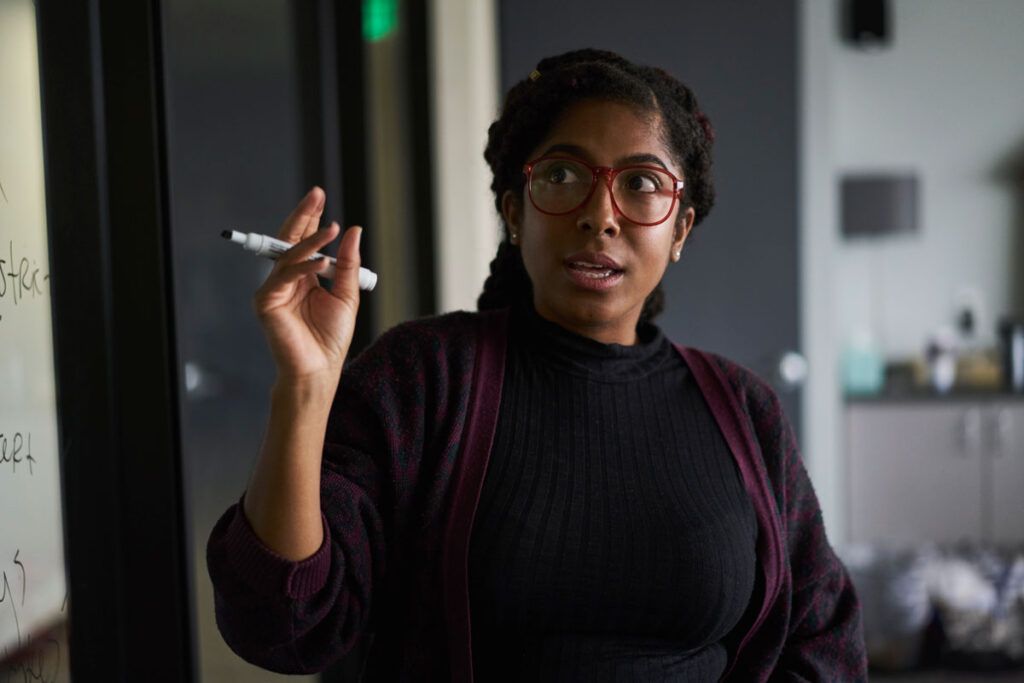 Young woman experiencing performance anxiety during a presentation at work