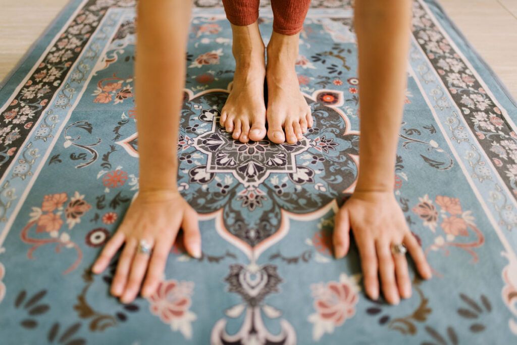 Adult practicing a yoga pose on the floor