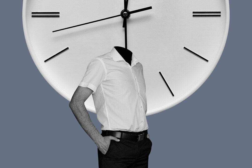 A body with no head standing in front of a large clock, representing how long migraine attacks last.