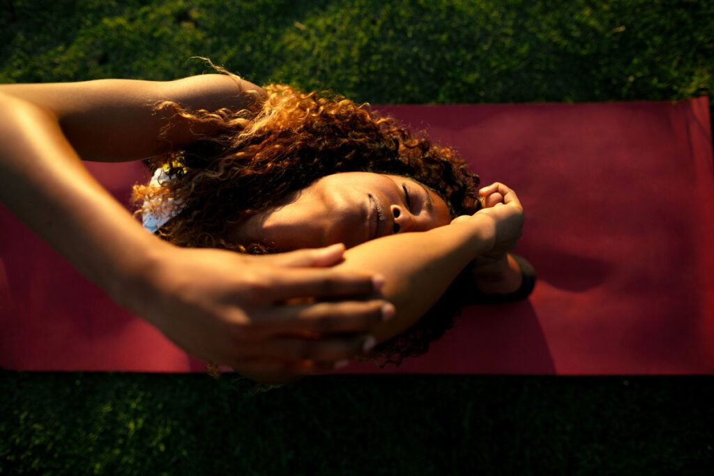 Woman practicing yoga to lower cortisol levels