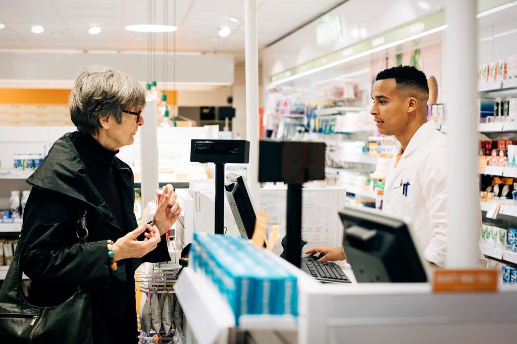 Customer using Perks prescription discount card at a pharmacy