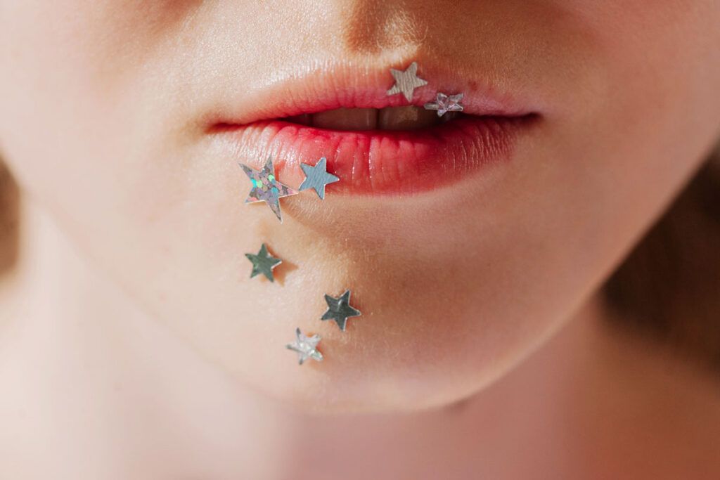 Woman with star stickers around the mouth symbolizing HPV bumps on the lips
