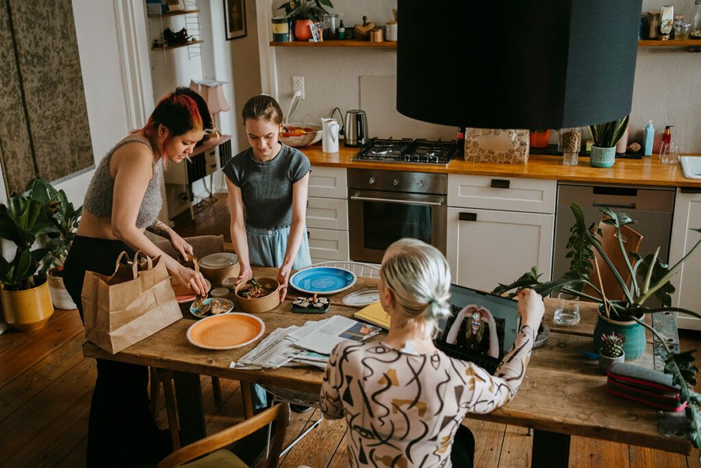 A family happily setting a table together. They may be using venlafaxine to treat anxiety.