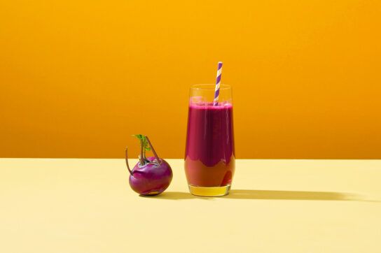 Beet juice for blood pressure in a glass next to a beetroot