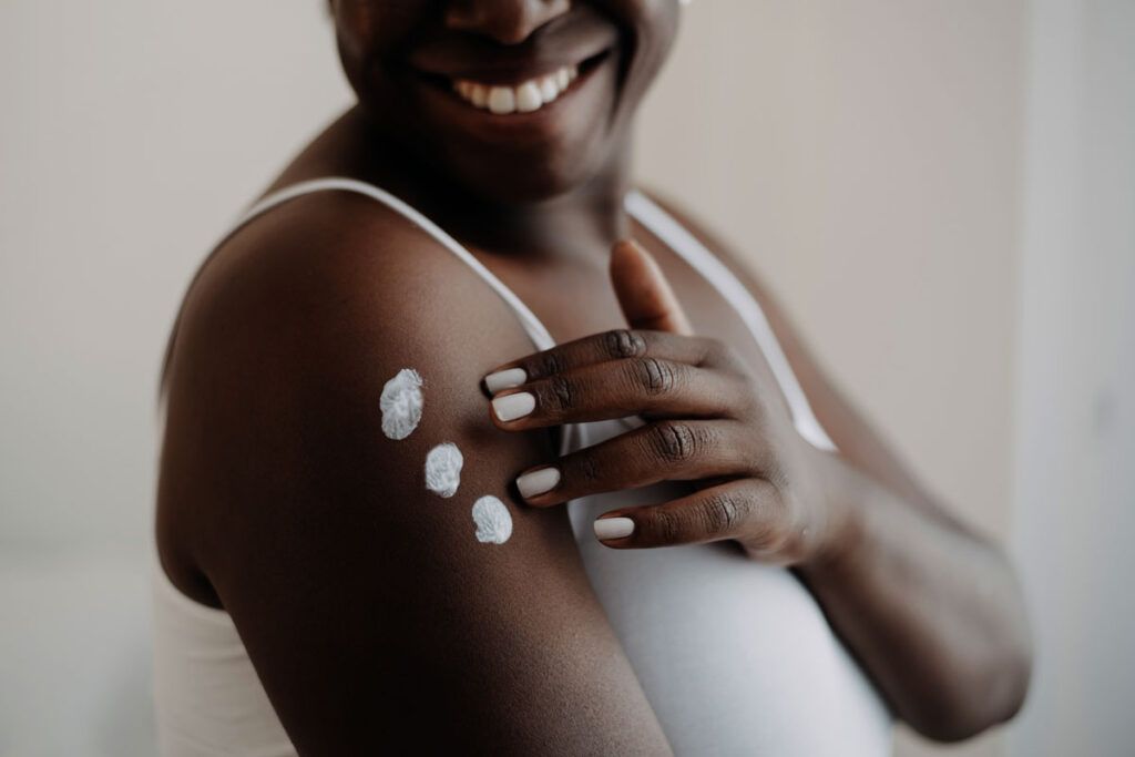 Woman applying mupirocin cream on the arm to quickly resolve a rash