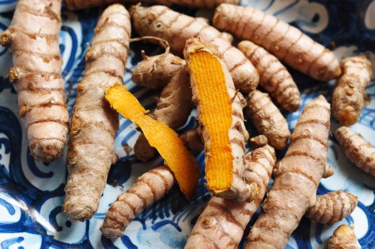 Several pieces of raw turmeric.