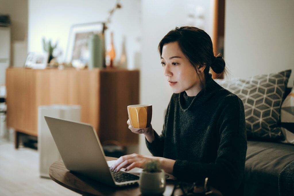 Woman on her laptop signing up for health insurance during open enrollment