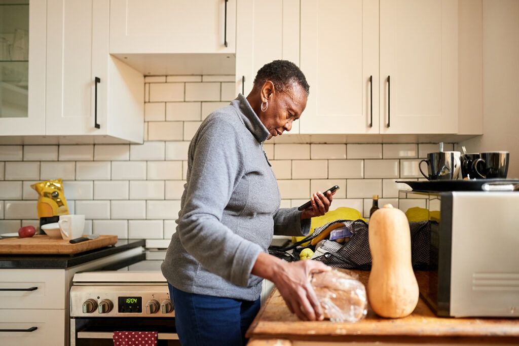 Person standing by their kitchen counter in front of a butter nut squash to depict foods to avoid while taking Zetia.