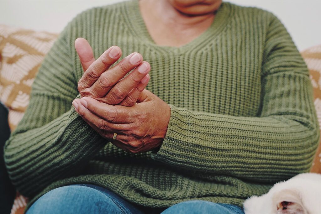 Woman taking arthritis medications for joint pain in the hands