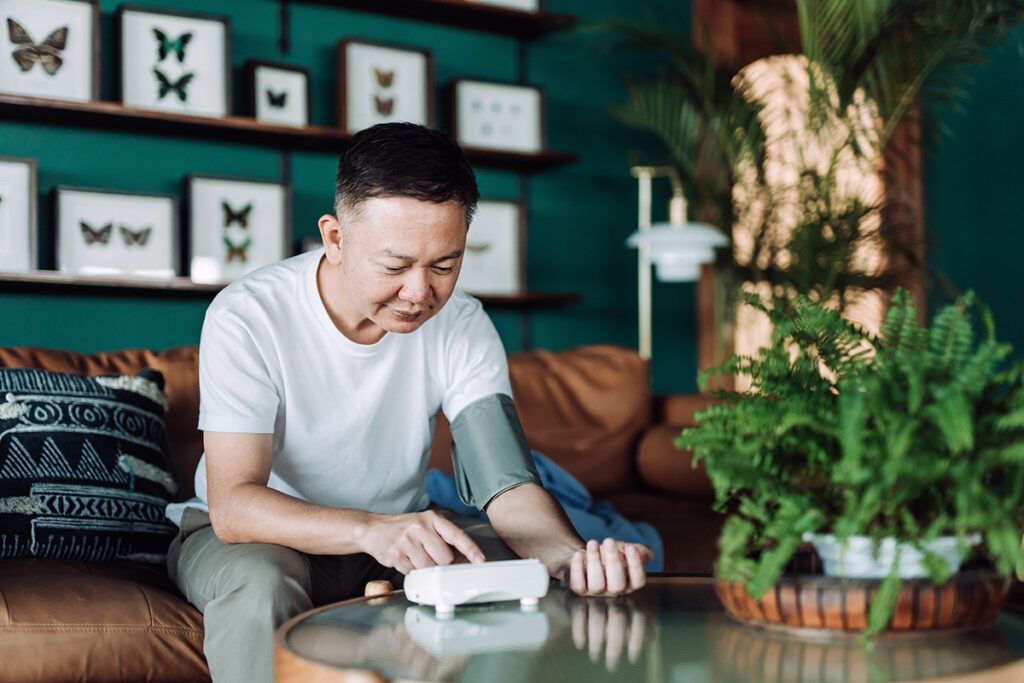 Adult male taking his blood pressure after taking losartan