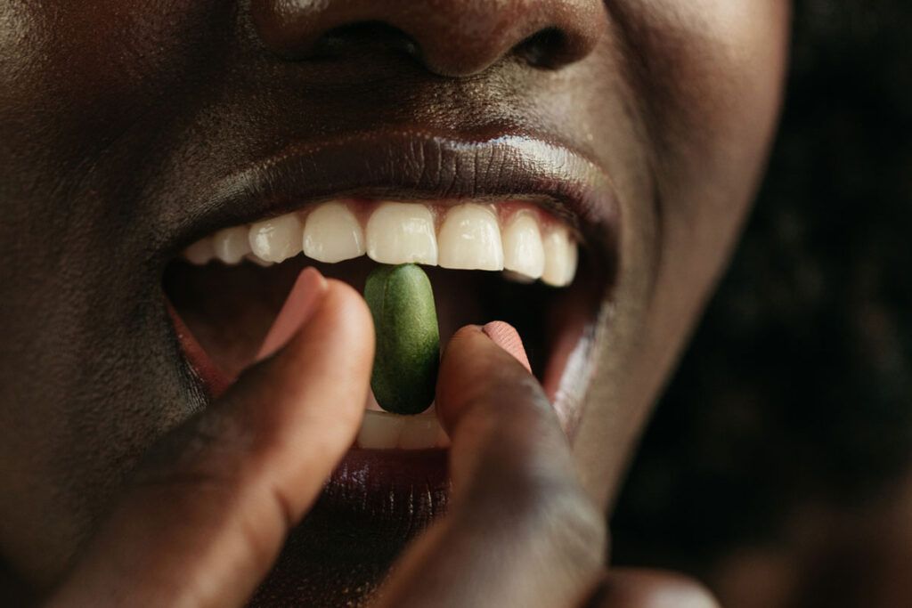 A close up of a person's mouth as they take one of the most common antibiotics