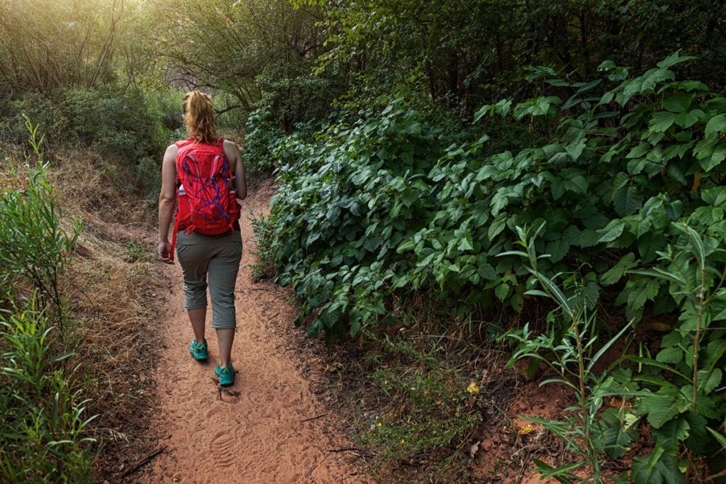 Woman hiking after being exposed to poison ivy and wondering if mupirocin will help